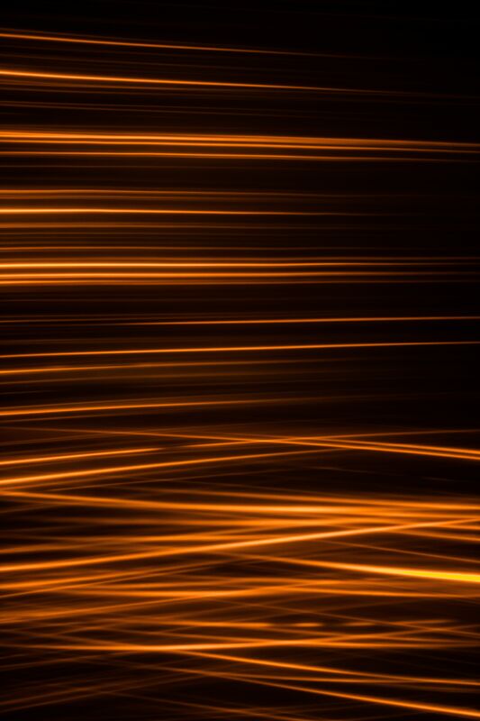 Abstract orange light trails on a dark background